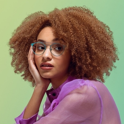 woman wearing cyan colored scott harris eyeglasses
