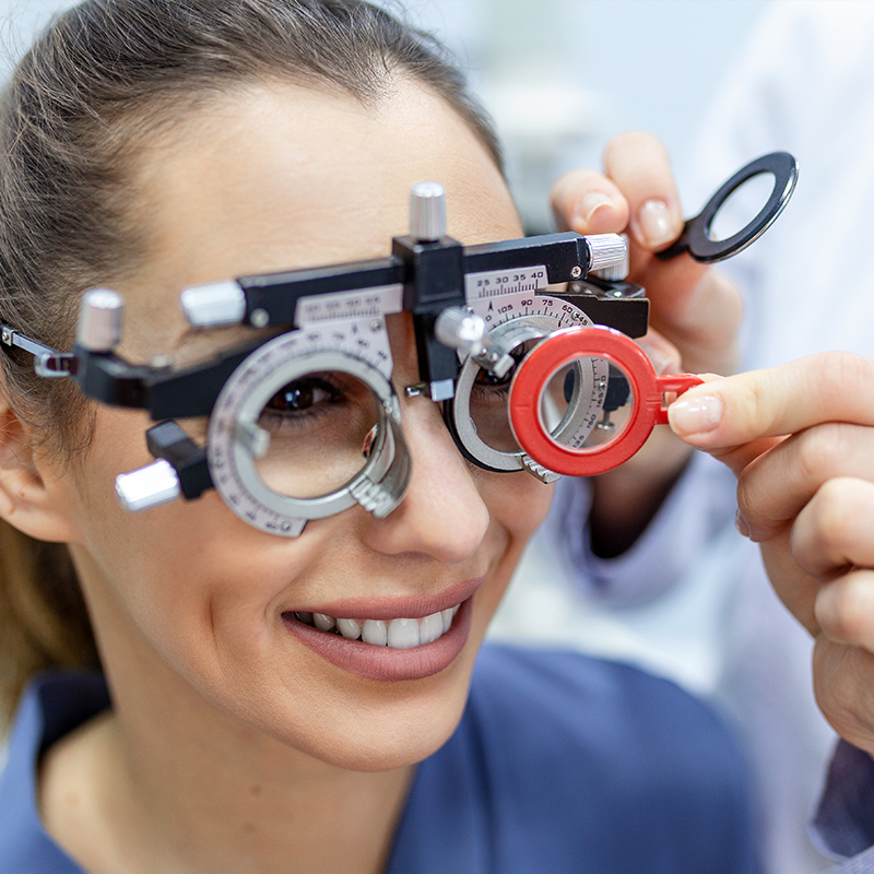 older woman having eyes tested using advanced equipment