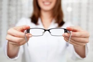 optician holding eyeglass frames