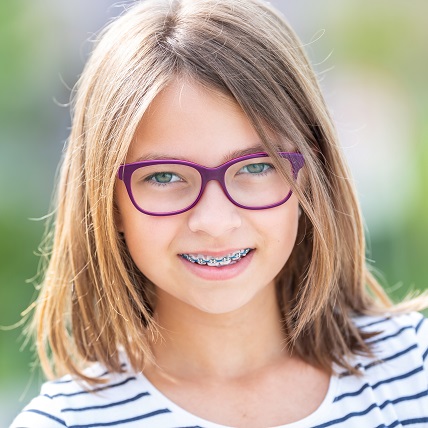 Young girl with braces and eyeglasses