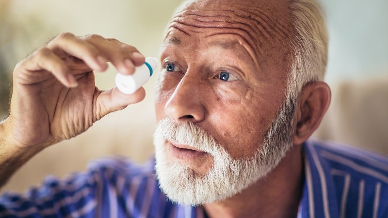 elderly man using glaucoma drops 16×9