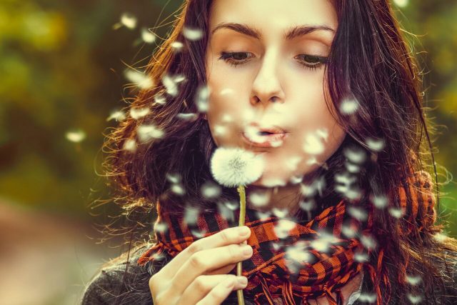 woman blowing flower, optometrist near you treats eye allergies