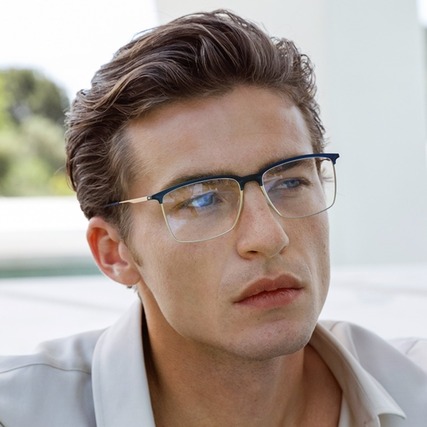 man wearing rimless silhouette eyeglasses