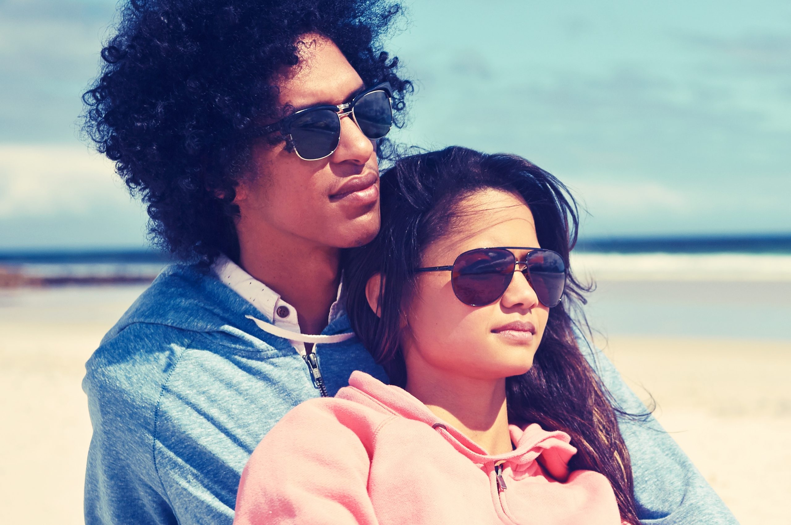 couple modelin sunglasses by lake