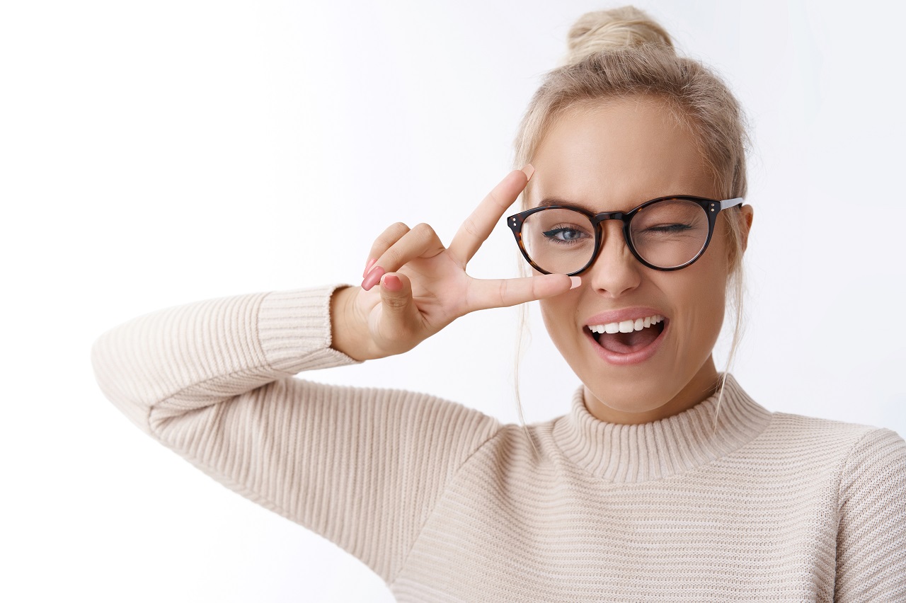Woman winking behind eyeglasses
