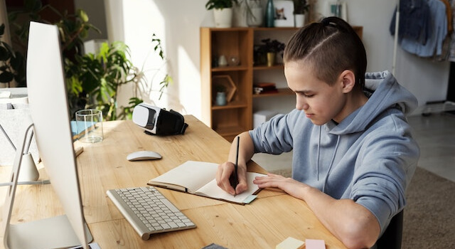 boy in front of a monitor doing his homework_640x350