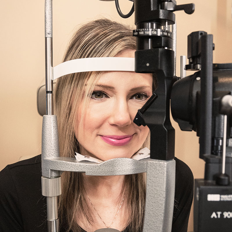 Female smiling while getting her eyes tested