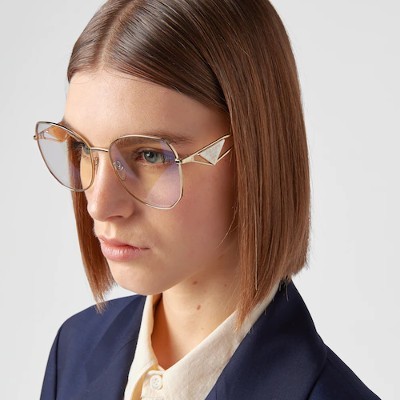 woman wearing gold tinted prada eyeglasses