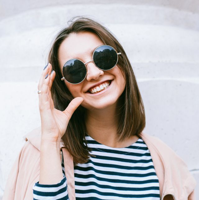 Young Woman Wearing Round Sunglasse