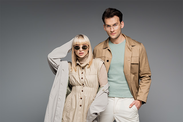 Male and Female Models Wearing Designer Glasses Grey Background