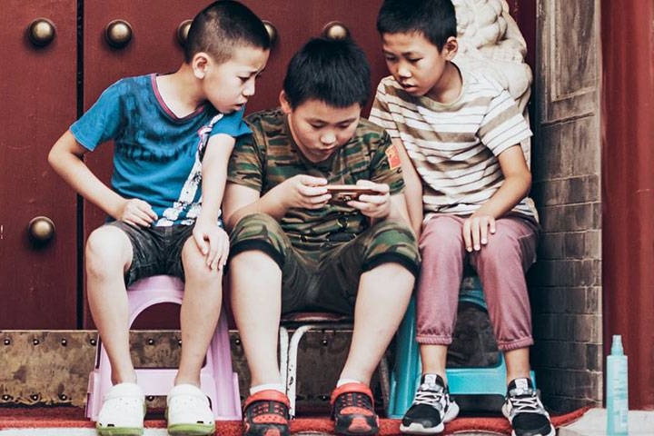 Boys playing games on phone
