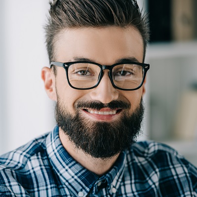 bearded smiling man in eyeglasses