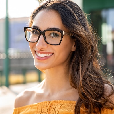 young woman outdoors modeling eyeglasses