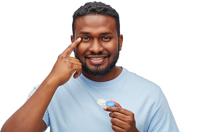 young african american man applying contact lenses