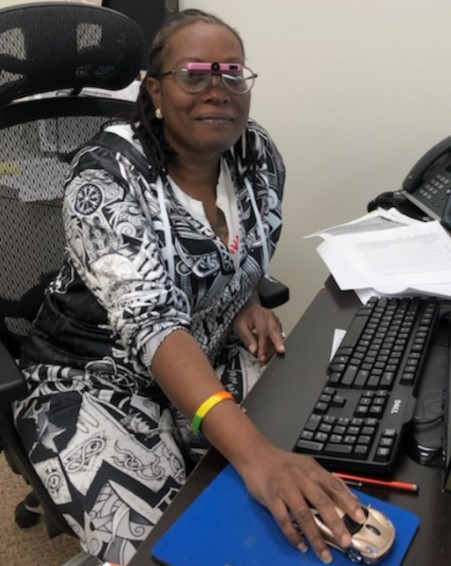 woman at computer with low vision glasses