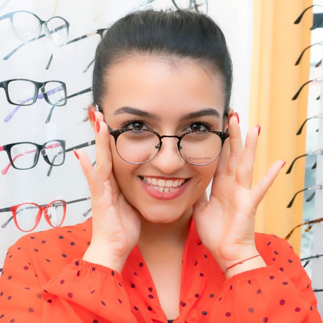 Optician selecting designer eyeglasses