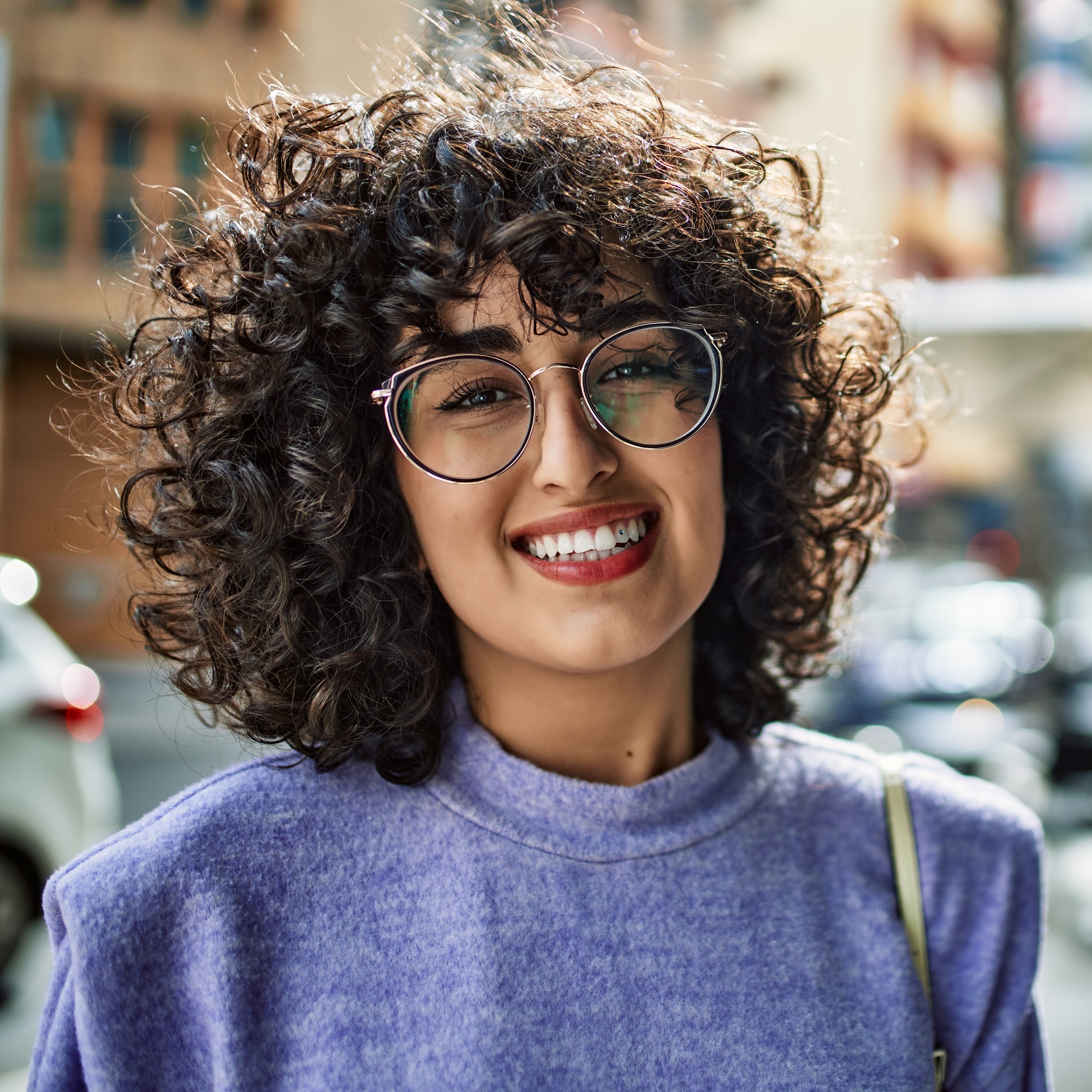 woman smiling confident wearing glasses at street