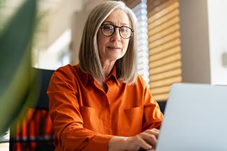 Female Working on Laptop Wearing Glasses