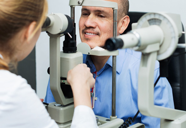 Man Having Eyes Examined by Female Doctor