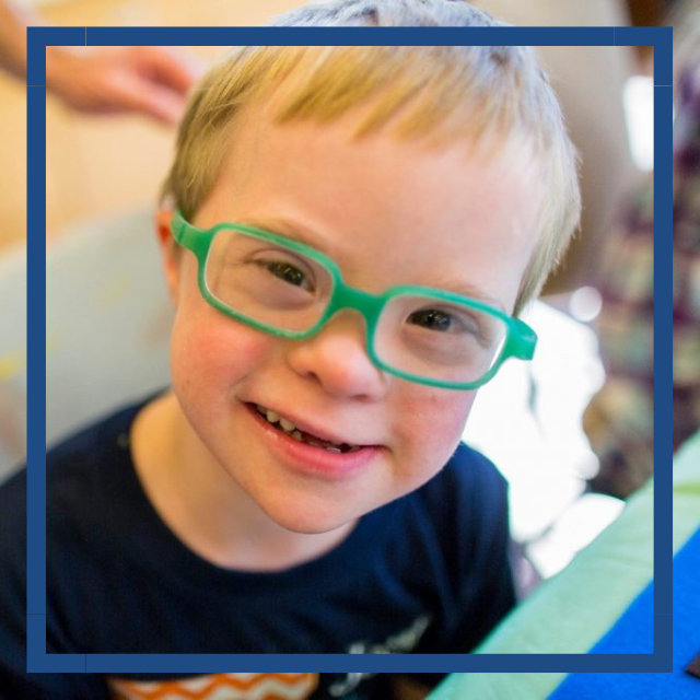 Down syndrome child wearing glasses