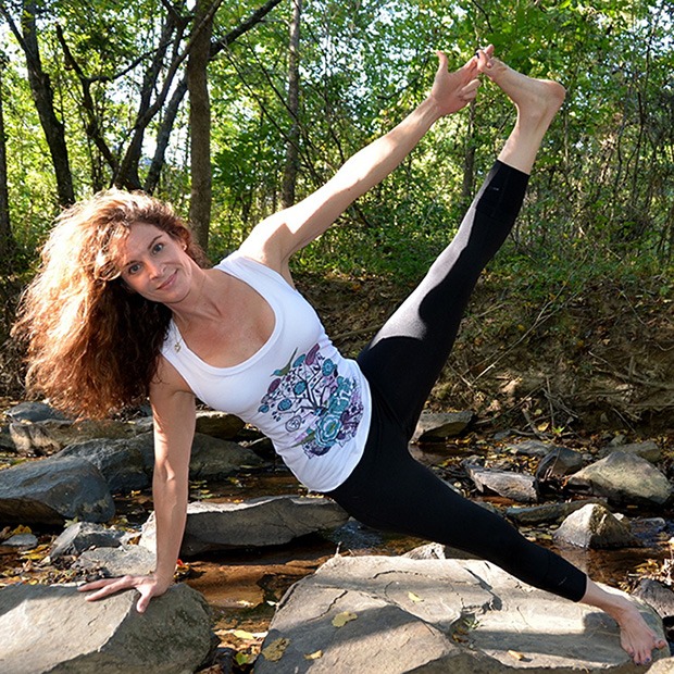 Young woman doing yoga exercises outdoors