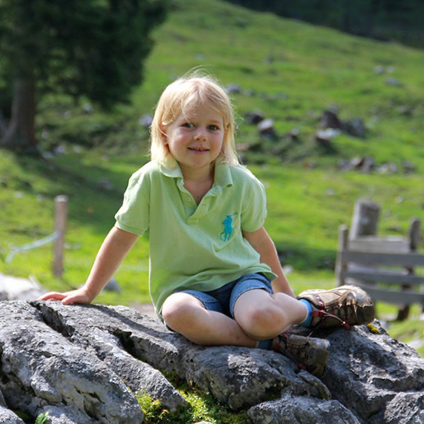 Young girl posing outside on a large rock