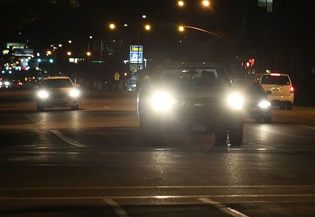 Picture of cars driving at night with headlights on
