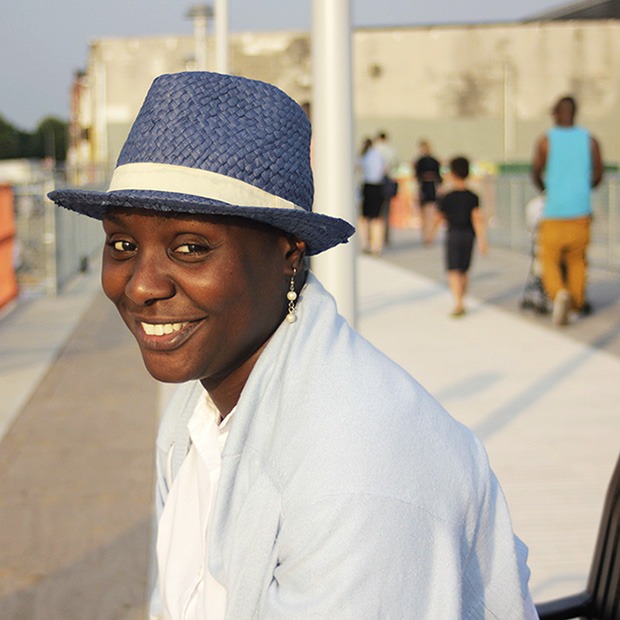 Adult woman smiling at camera, blue hat