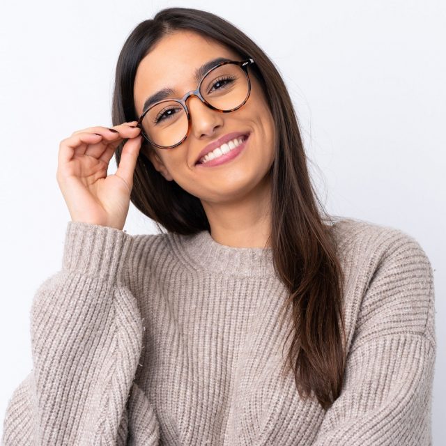 Young adult smiling with glasses