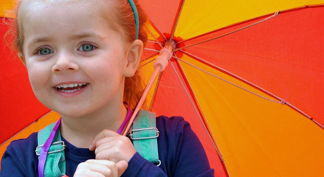 kid with umbrella pediatric eye care.640×350