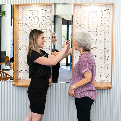 Female Fitting Glasses On Patient