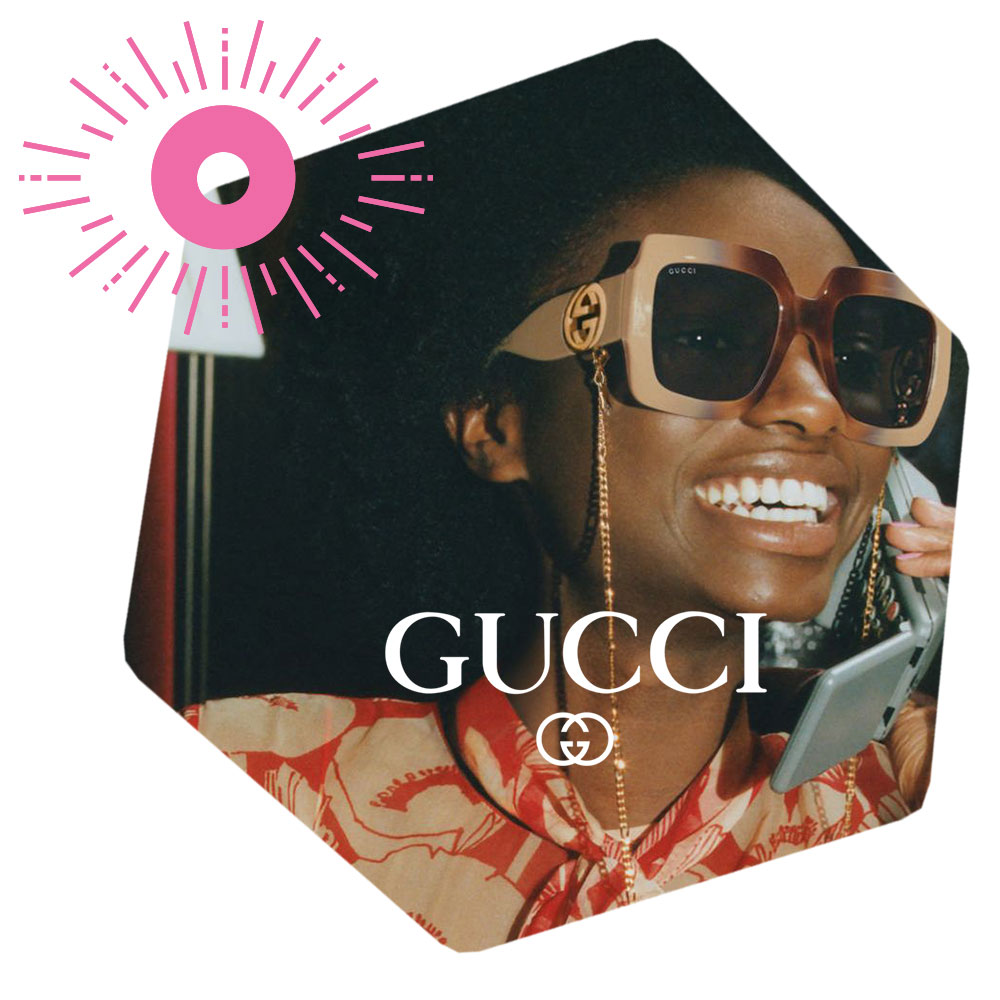 African American Female Smiling Talking on the phone wearing Gucci Sunglasses