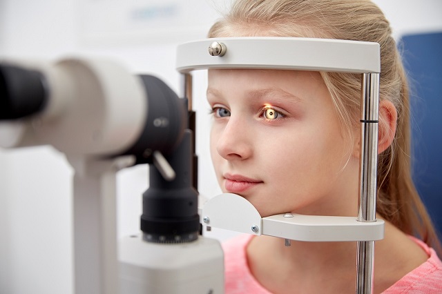 young girl eye exam slit lamp