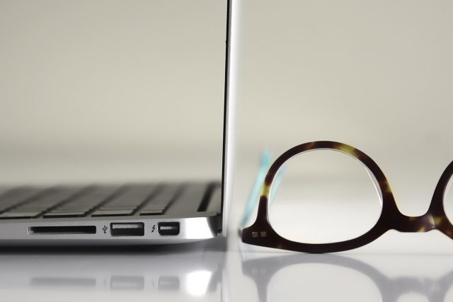laptop and eyeglasses on desk