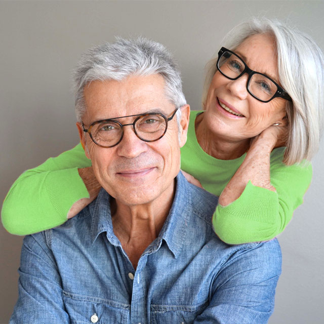 trendy senior couple wearing glasses