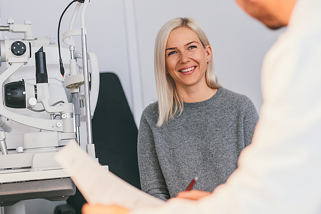 smiling middle aged woman with eye doctor