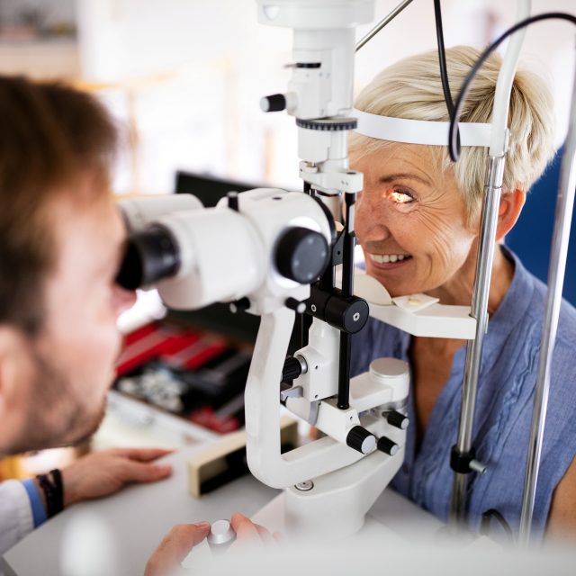 optometrist and woman patient eye exam