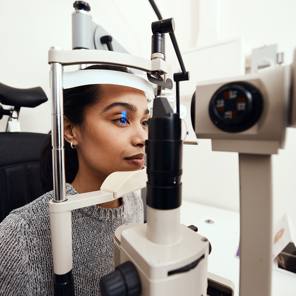 Doctor Performing Eye Exam On Female