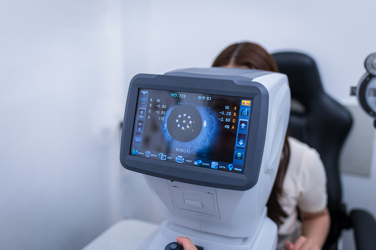 woman having eyes tested using advanced equipment