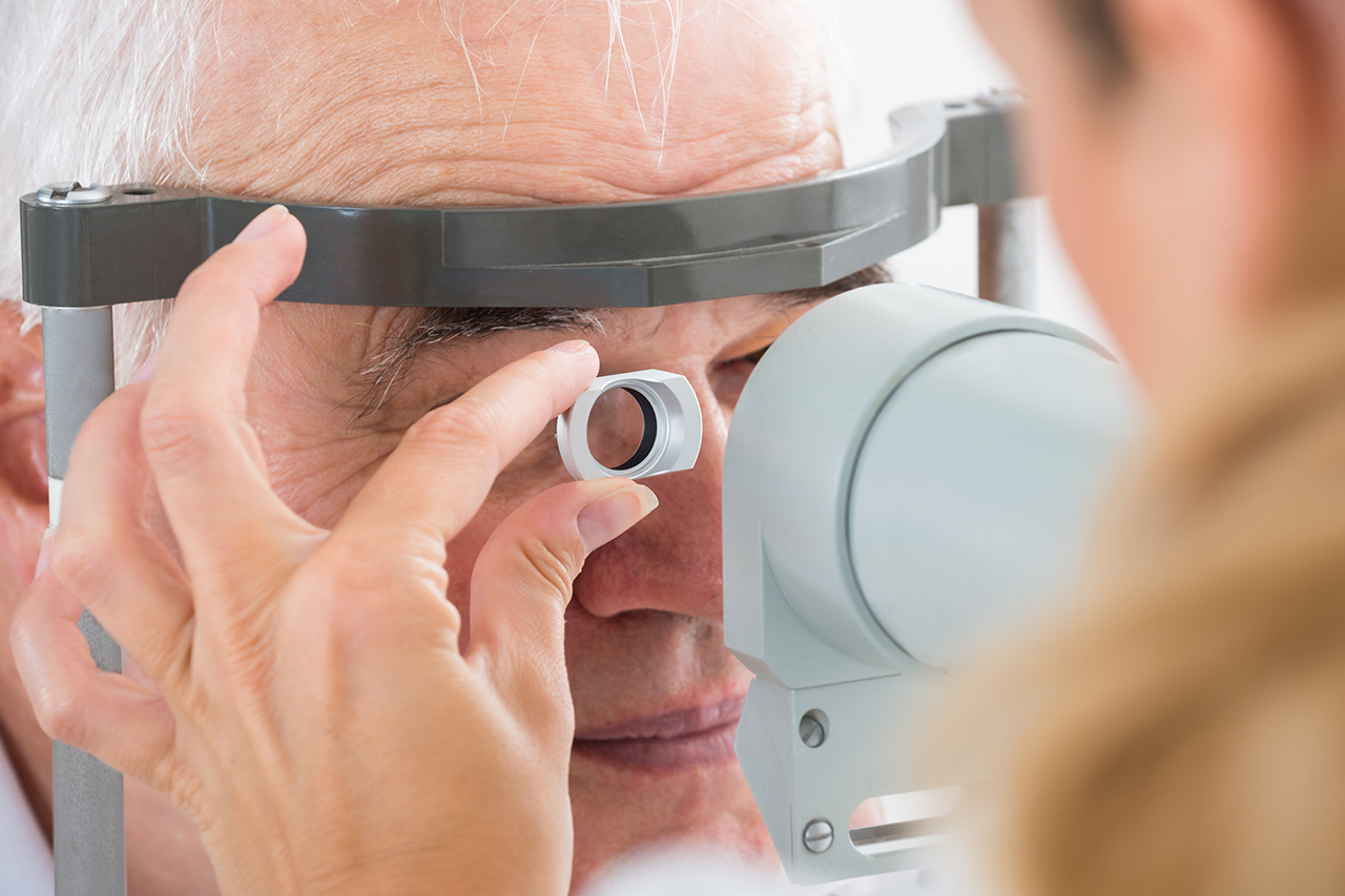 senior male having eyes tested