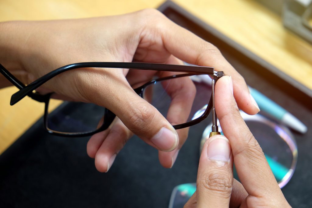 optician hands repairing eyeglasses