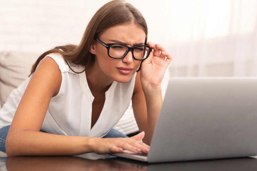 Girl Looking At Laptop Having Eyesight Problem At Home