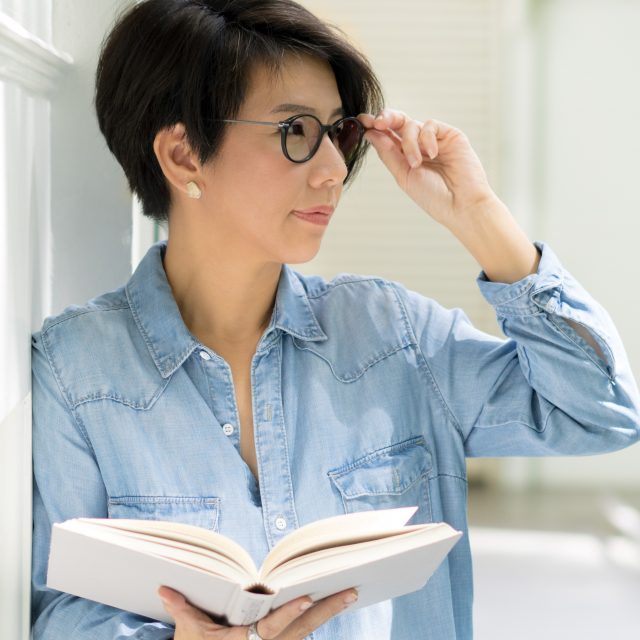 middle aged woman reading book rev