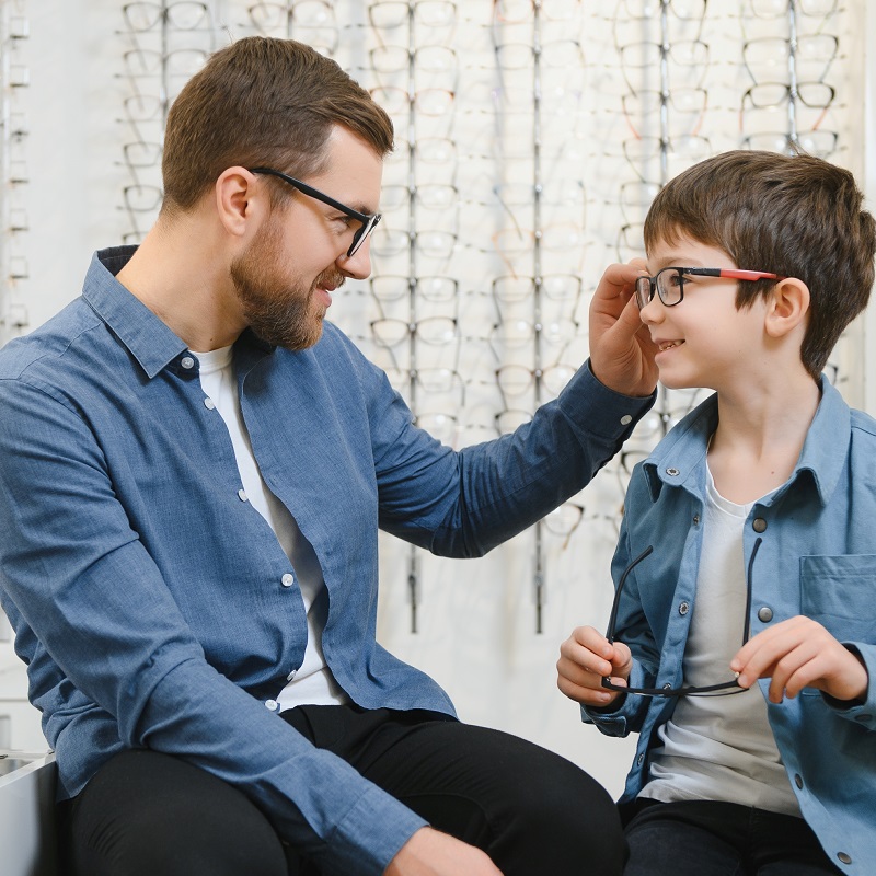 father and son choosing new eyeglasses
