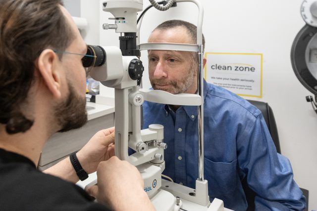 optometrist examining male patient 640x427