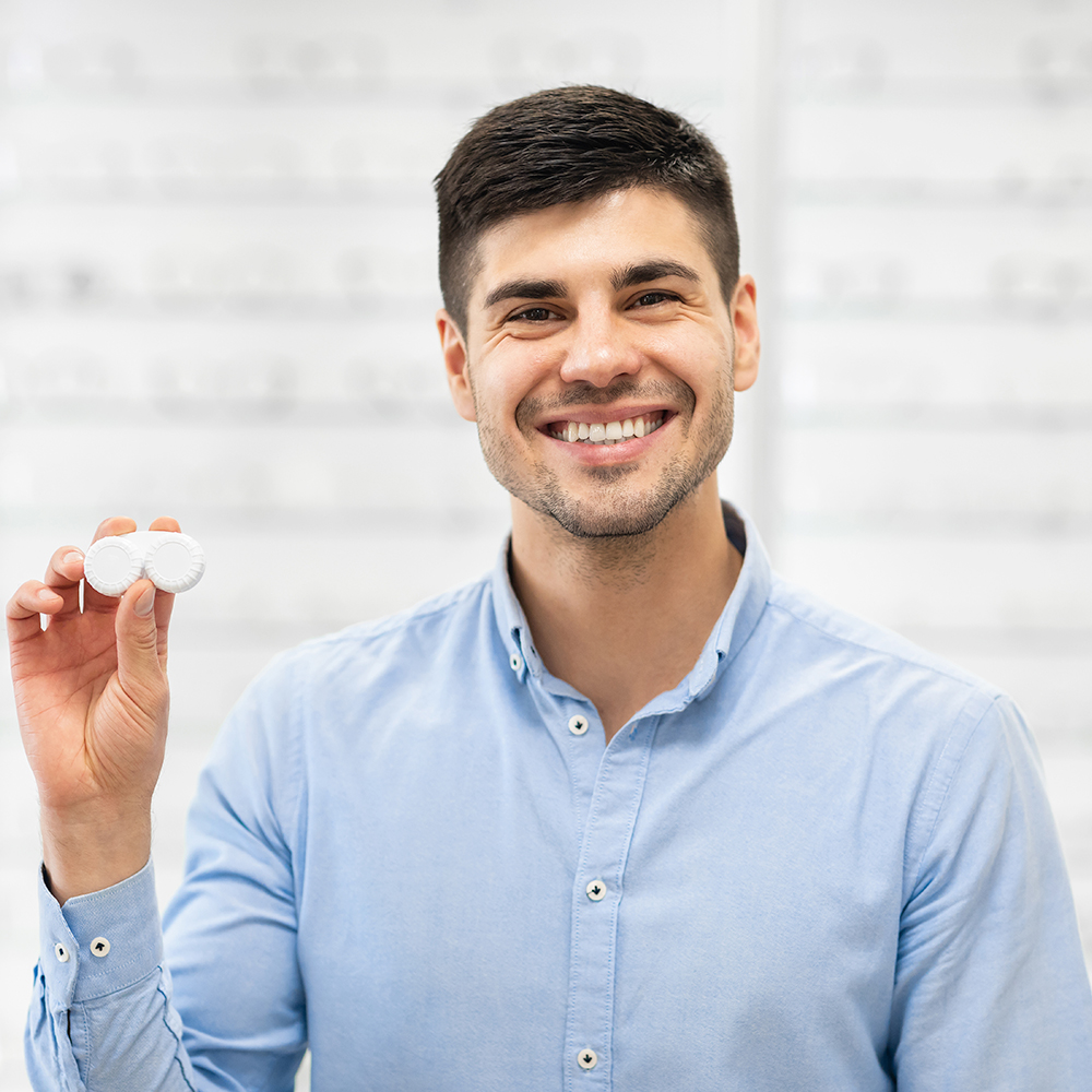 Man holding contact lenses
