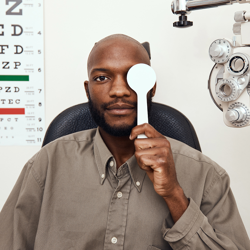 Shot of a young man covering his eye with an occluder during an eye exam