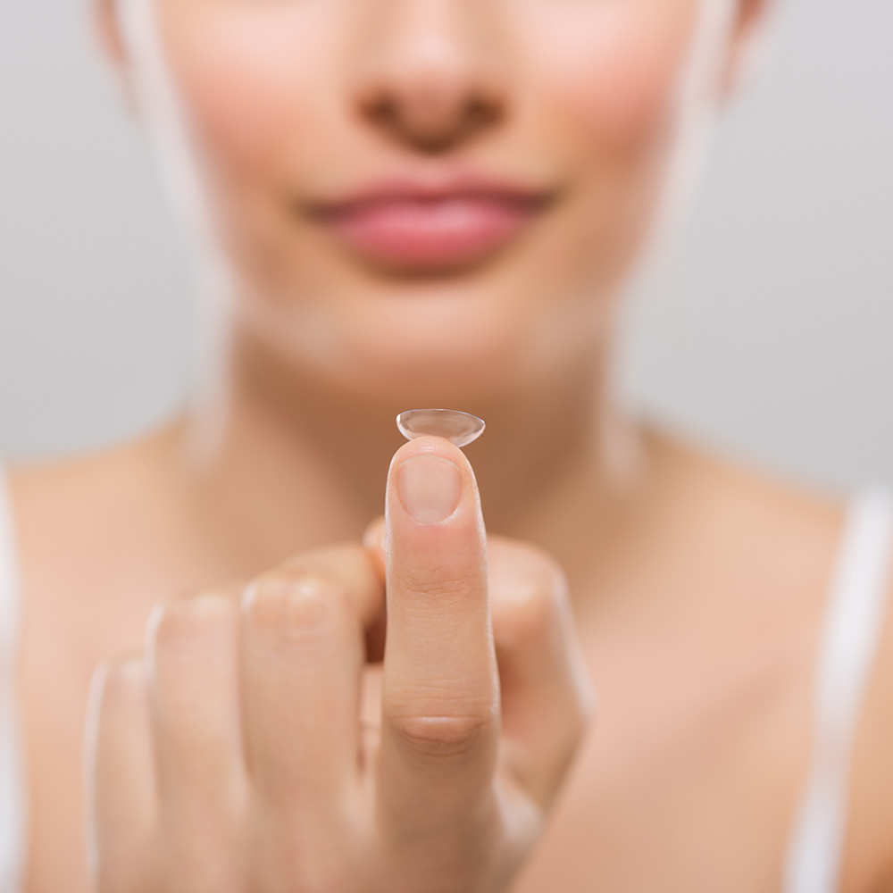 Female Holding Contacts On Her Finger