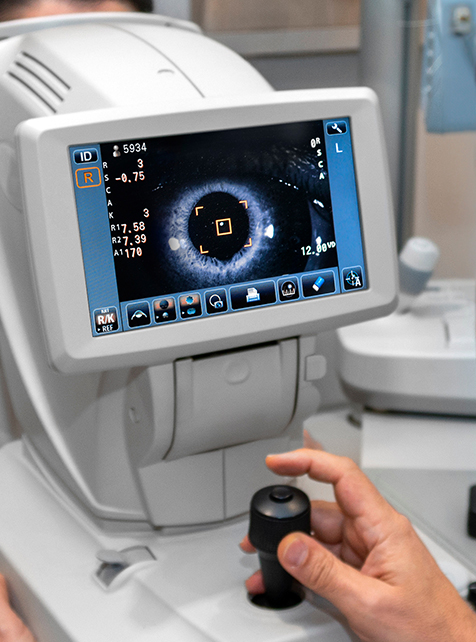 Lady looking at refractometer eye testing machine in ophthalmology tonometer