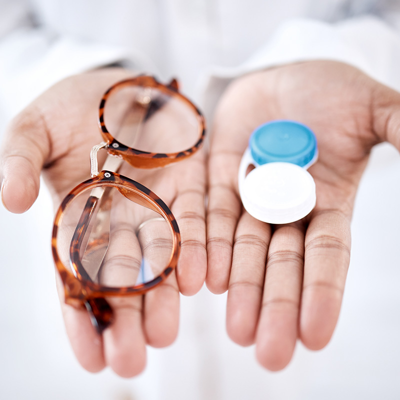 Eye care, choice with glasses or contact lenses in hands, closeup and vision with healthcare for eyes.